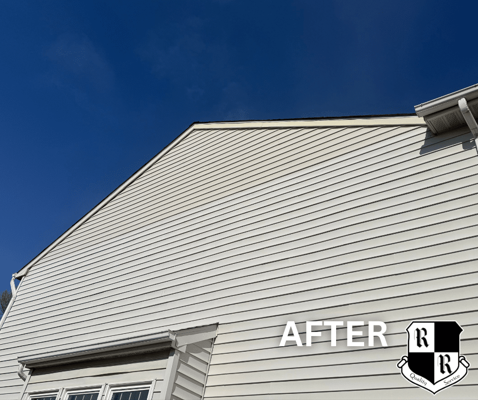 Newly installed light siding on a house with a deep blue sky; 'AFTER' label and a crest-shaped logo in the corner.
