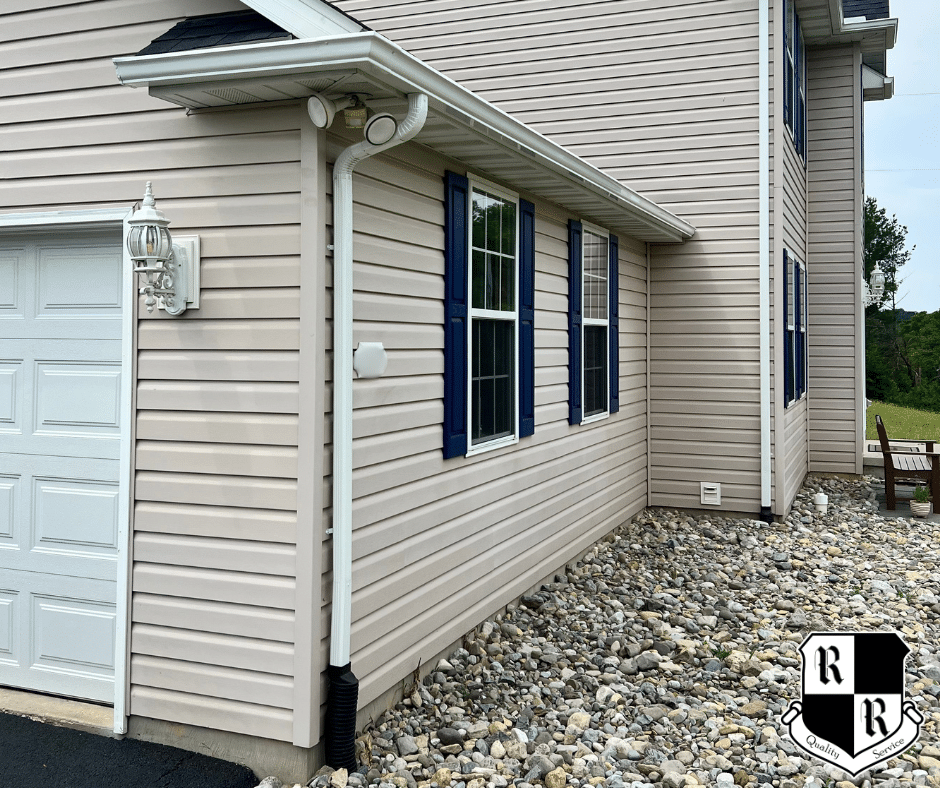 This is an image of a seamless gutter replacement by Roof Right in Westminster, Maryland featuring white, K-Style gutters and downspouts.
