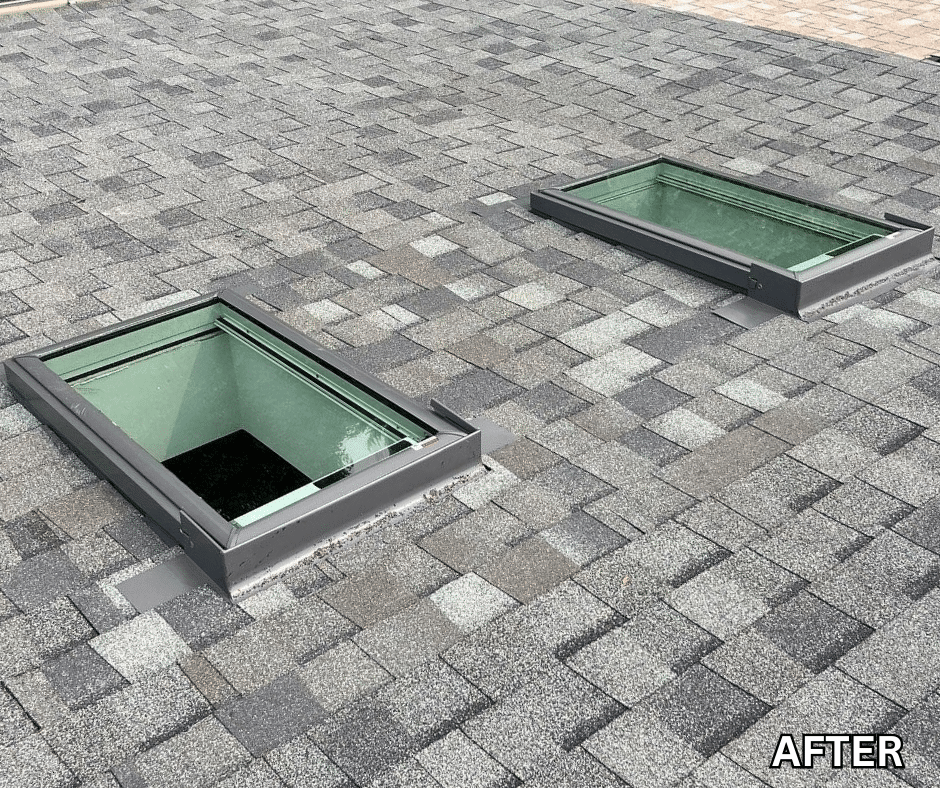 Two rectangular green skylights with metal frames installed flush on a gray shingled roof (renovation result).